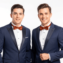 Load image into Gallery viewer, Two men in navy suits wearing rust leather bow ties, ideal groomsmen wedding look