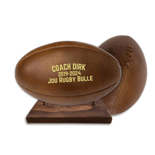 Load image into Gallery viewer, Personalised leather rugby ball with custom branding South Africa handcrafted gift on wooden ball stand.