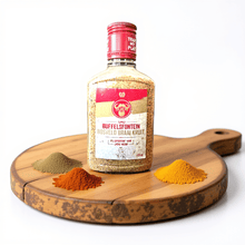 Load image into Gallery viewer, Buffelsfontein Bosveld Braai Spice  on a wooden board with spices surrounding it. 

