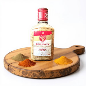 Buffelsfontein Bosveld Braai Spice  on a wooden board with spices surrounding it. 