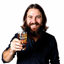 Load image into Gallery viewer, Man holding a Buffelsfontein Brandewyn branded brandy glass filled with brandy on ice.
